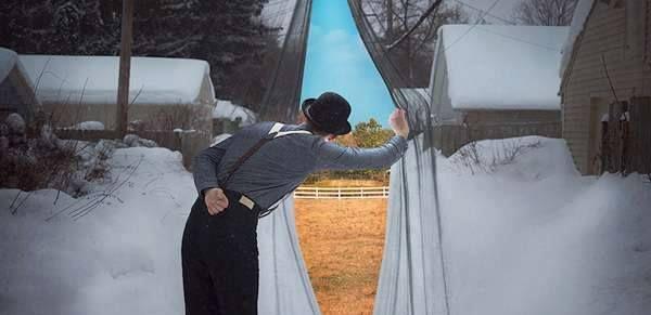 Man looking through Winters curtain for signs of Spring