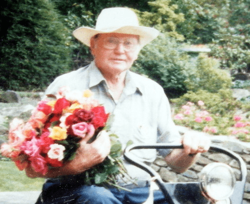 Albert Behnke on his golf cart with a handful of roses